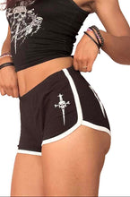 Load image into Gallery viewer, model wearing a black crop top and shorts with white designs on a white background