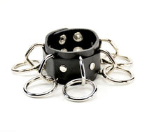 Load image into Gallery viewer, black leather bracelet with five silver d rings with five hanging silver o rings attached. shows snap closure