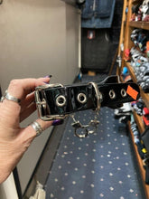 Load image into Gallery viewer, Black leather collar with silver D ring details, and two silver handcuffs hanging from two silver chains.