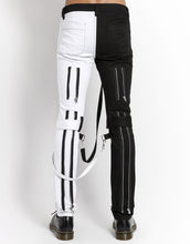 Load image into Gallery viewer, back of Classic slim White/Black split leg pants with removable bondage straps and zipper details. Pant legs can be zipped for a change in fit, topped off with a zip fly and button closure.