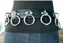 Load image into Gallery viewer, person wearing black leather bondage belt with nine silver hanging o rings