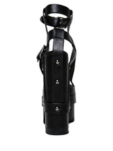Load image into Gallery viewer, back view of black vegan leather strappy platform sandal with 6.5" heel. Sandal has gunmetal hardware, adjustable ankle strap and adjustable side strap. Bottom of front platform has a fanned grip for better stability.