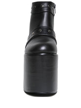 Load image into Gallery viewer, front view of black vegan leather super tall 6" heel, 4" platform sleep design boot. Boot has a rivet studded strap that wraps around and is removable or attachable with Velcro. Boot has black EVA platform.