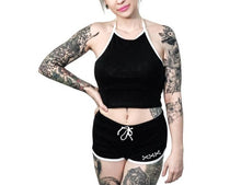 Load image into Gallery viewer, Women&#39;s black shorts with whitetrim and white skeleton hand middle finger design on right buttcheek, white drawstring and white cross bones on front left
