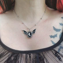 Load image into Gallery viewer, Silver colored zinc alloy bat wing necklace with silver crescent moon in center.