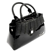 Load image into Gallery viewer, side view of Glossy black purse with silver lock detail on front center. The shell is comprised of glossy black faux leather, with matte leather stitched spiderweb details near the top. Zip closure, inner pockets and little metal feet.