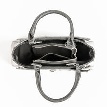 Load image into Gallery viewer, inside view of Glossy black purse with silver lock detail on front center. The shell is comprised of glossy black faux leather, with matte leather stitched spiderweb details near the top. Zip closure, inner pockets and little metal feet.