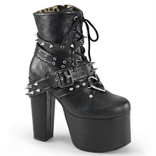 Load image into Gallery viewer, outer side view of black vegan leather 5 1/2&quot; heel 3&quot; platform Lace-up front Ankle boot Features wrap around buckled straps with spikes &amp; eyelets and heart O-ring on vamp with Inside zip closure
