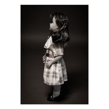 Load image into Gallery viewer, talky tina replica doll with pig tails, wearing a plaid dress with bow around the waist, and black flats with white socks
