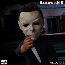 Load image into Gallery viewer, Doll wears tailored, weathered coveralls, features 11 points of articulation, and comes complete with a butcher knife accessory that fits neatly in his right hand.