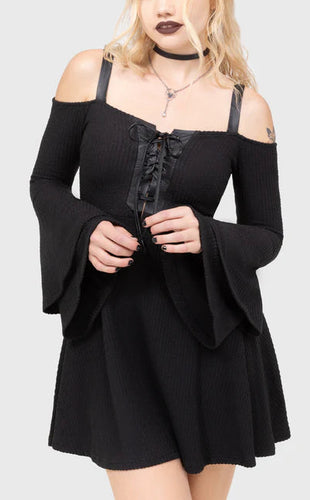 Model wearing a black dress with long sleeves and lace-up front on a white background