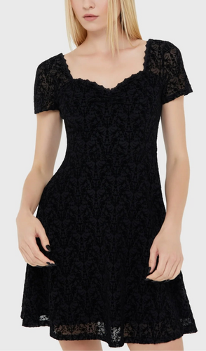 Model wearing a black lace dress on a white background