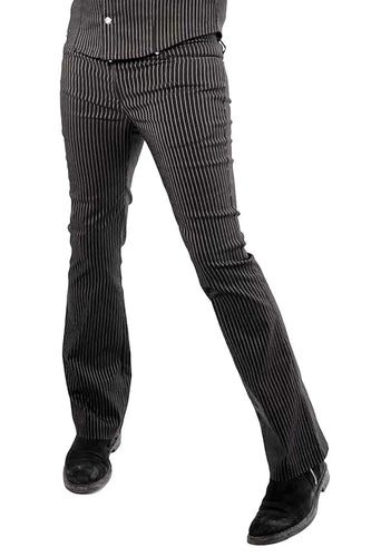 Model wearing black and white pinstripe pants worn n a white background