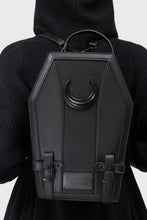 Load image into Gallery viewer, Model wearing black coffin-shaped backpack with a crescent moon design on a plain background
