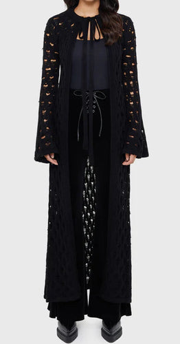 Model wearing a black floor length cardigan on a white background