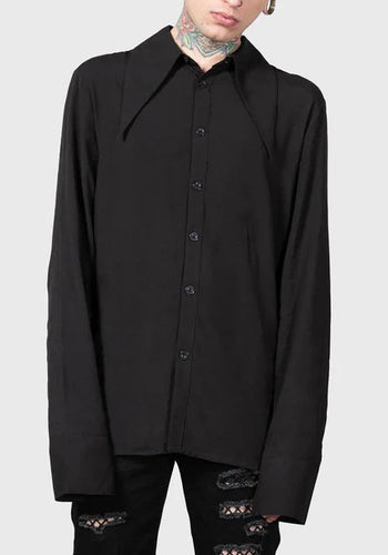 Person wearing a black shirt with a plain background