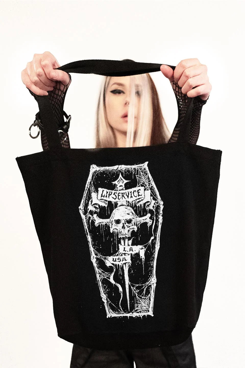 model holding tote bag