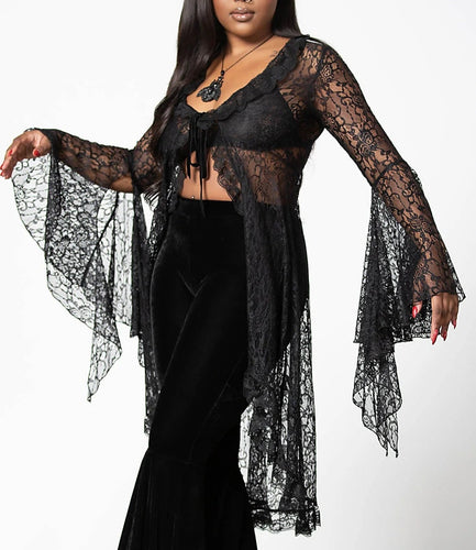 Model wearing a black lace top with a plain background
