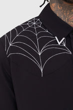 Load image into Gallery viewer, Model wearing a black button up shirt with spider web designs near collar on a white background
