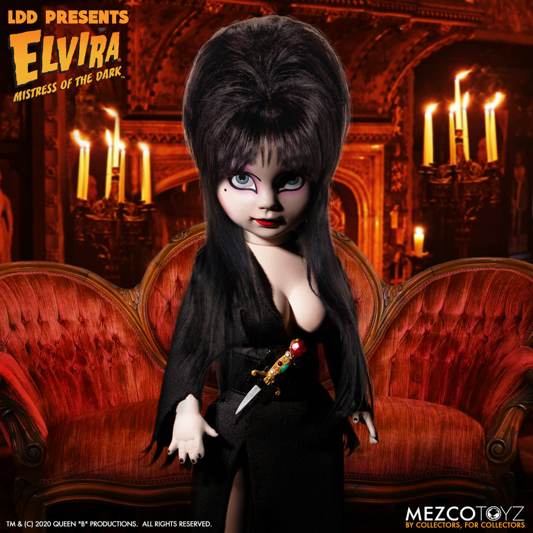front view of Elvira Living Dead Doll, with iconic black dress and batty, teased hair, and comes with a dagger that she can store in her waist belt. Stands 10” tall and features 5 points of articulation. Packaged in window box for display.