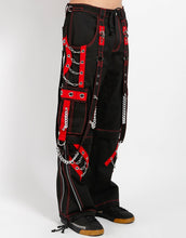 Load image into Gallery viewer, side of Black and red pants feature red stitching, removable straps, adjustable ankles, D-rings, clasps, and deep pockets.

