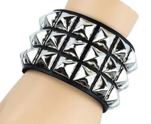 Load image into Gallery viewer, Black leather bracelet with three rows of silver pyramid studs.
