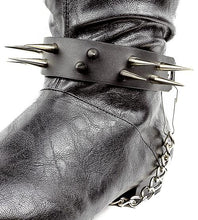 Load image into Gallery viewer, close up shot of black boot displaying black boot strap  that has two rows of multiple silver sharp pointy spike studs and hanging silver chain 
