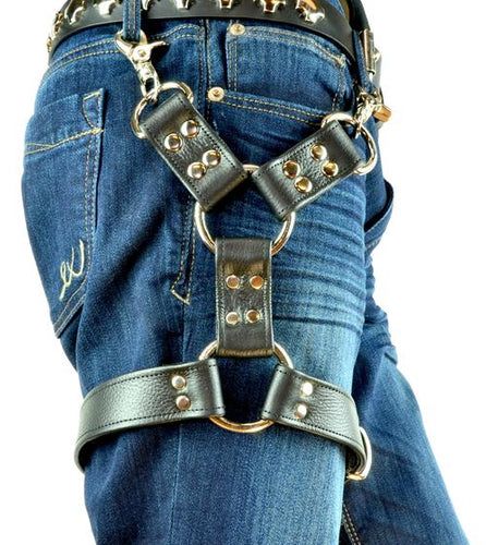 person wearing black leather leg harness with two belt loop clips on the top, and two large o rings on the bottom