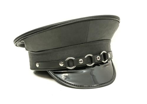 Black vegan leather captains hat with shiny patent vegan leather bill. Front of hat has three silver O ring details across the front.
