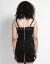Load image into Gallery viewer, back of Short black dress with adjustable straps and bondage belt details all over the front and back of the dress.
