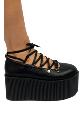 Load image into Gallery viewer, Black vegan leather upper, silver chrome hardware, black molded bottom. Top of Mary Jane laces up through D rings, and then ties around the ankle.
