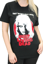 Load image into Gallery viewer, person wearing black night of the living dead movie shirt with picture of kyra schon and text that reads &quot;they won&#39;t stay dead. night of the living dead&quot;
