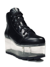 Load image into Gallery viewer, outer view of black vegan leather platform shoe with clear plastic platform. Shoe looks like a sneaker, but is super tall! Clear plastic bottom has a Velcro foot bed opening, to insert toys, candy or fun stuff into the clear bottom of the shoe.
