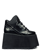 Load image into Gallery viewer, inner view of black vegan leather platform shoe with EVA platform. Shoe looks like a sneaker, but super tall! Shoe has nylon details and mesh lining. Bottom of platform has a &quot;fanned&quot; grip to make the platform more stable.
