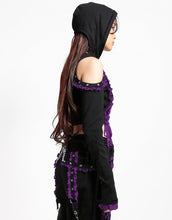 Load image into Gallery viewer, side of Black hoodie with gothic lolita details. Hoodie has long sleeves that have thumb holes and purple lace around the hands. Shoulders are open, and have edges of black and purple lace details, as well as silver rivet details around the edge. Front of hoodie zips up, and has purple and black lacey lace-up panels on right and left of zipper. Hoodie has black hood.
