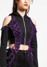 Load image into Gallery viewer, side of Black hoodie with gothic lolita details. Hoodie has long sleeves that have thumb holes and purple lace around the hands. Shoulders are open, and have edges of black and purple lace details, as well as silver rivet details around the edge. Front of hoodie zips up, and has purple and black lacey lace-up panels on right and left of zipper. Hoodie has black hood.
