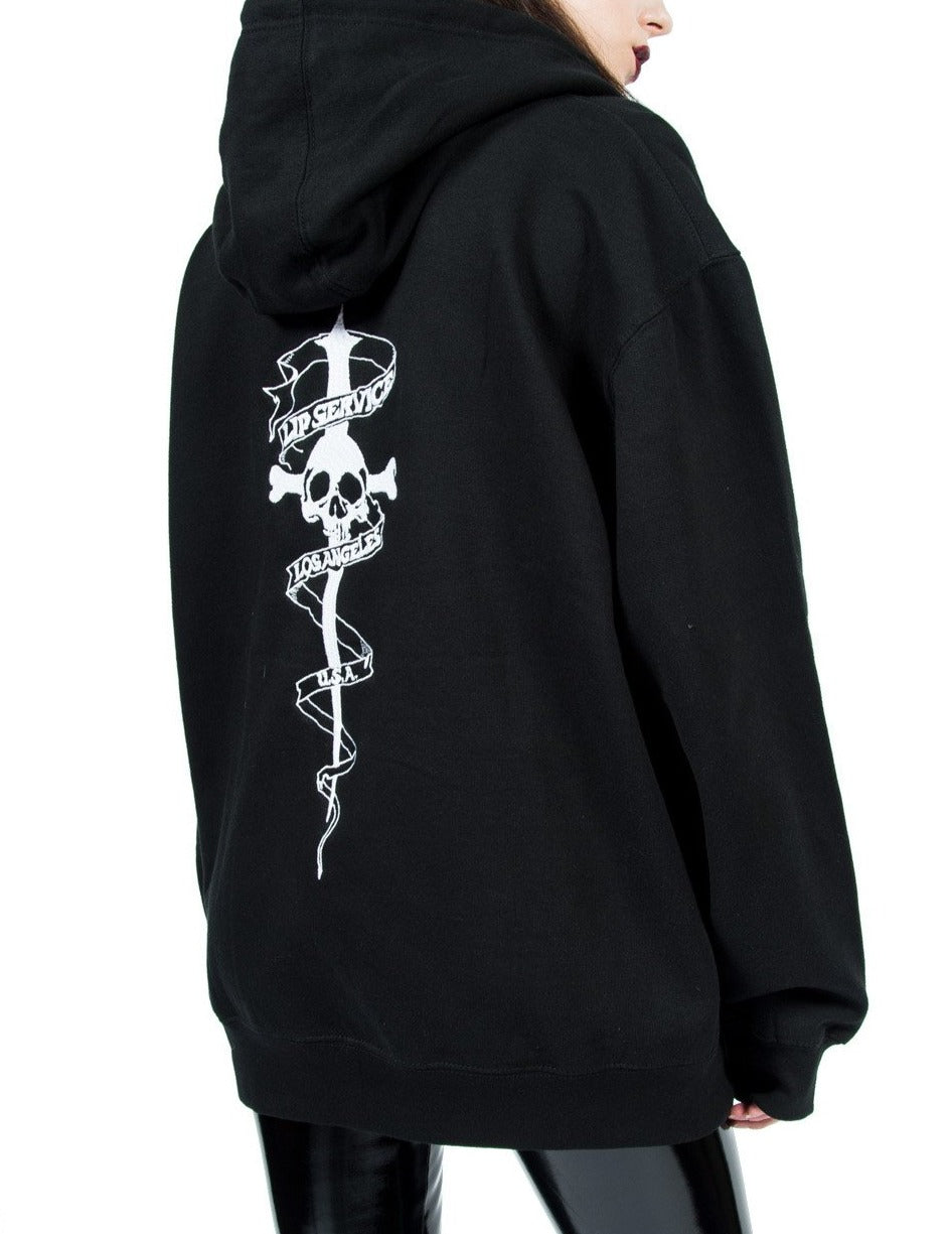 Black and white cross bones and dagger logo hoodie has print on the front and the back, with zip front closure and back hood.