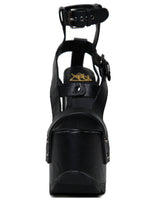 Load image into Gallery viewer, front view of black vegan leather strappy platform sandal with 6.5&quot; heel. Sandal has gunmetal hardware, adjustable ankle strap and adjustable side strap. Bottom of front platform has a fanned grip for better stability.
