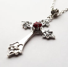 Load image into Gallery viewer, Silver colored zinc alloy vampire cross necklace with red cubic zirconia gem in center of cross.
