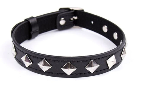 Silver pyramid studs placed with corners up to look like diamond shapes on black vegan leather choker.