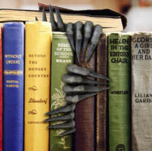 Load image into Gallery viewer, Black devil&#39;s claw hands bookmark inside of book

