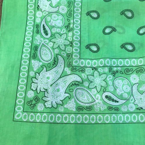 Green bandana with white and black paisley print.