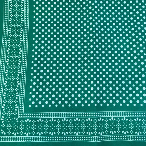 Green bandana with white polka dots pattern.