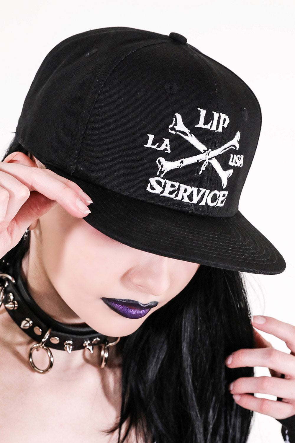 front view of Black hat with white embroidery that reads 