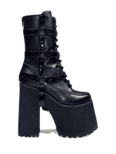 Load image into Gallery viewer, Black vegan leather super tall 6&quot; heel boot with black vegan patent leather O ring straps on the side, black enamel hardware and EVA bottom. Boot has full lace-up front and full back zipper.

