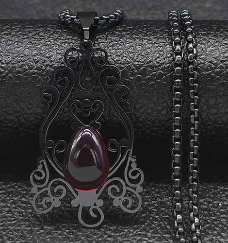 necklace on display with a black background