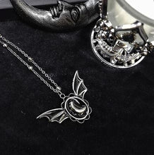 Load image into Gallery viewer, Silver colored zinc alloy bat wing necklace with silver crescent moon in center.
