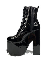 Load image into Gallery viewer, inner view of Black vegan shiny patent leather tall military style platform boot with black cotton laces and black inner zipper. Front of platform has a fanned grip for better stability when walking.
