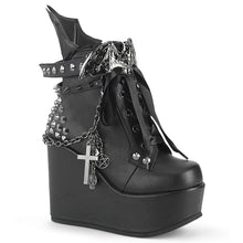 Load image into Gallery viewer, outer view of 5&quot; wedge platform Wedge ankle bootie style boot Features wrap around studded &amp; spike straps Bat buckle detail Chain with various hanging charms Batwing detail up the back Inside metal zip closure.

