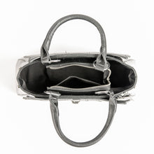 Load image into Gallery viewer, inside view of Glossy black purse with silver lock detail on front center. The shell is comprised of glossy black faux leather, with matte leather stitched spiderweb details near the top. Zip closure, inner pockets and little metal feet.
